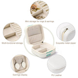 PU leather travel jewelry box for women with 'Design Here' text, featuring storage for rings and earrings.