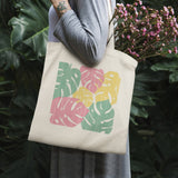Monstera leaf print canvas tote bag, perfect for shopping, in pink, yellow, and green, cotton eco-friendly bag for women.