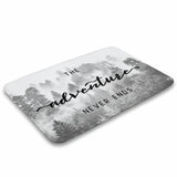 Coral velvet bath rug with misty forest design and "The adventure NEVER ENDS" for bathroom.