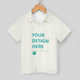 Customizable kids' polo shirt. White with yellow heart pattern and 'Your Design Here' text.