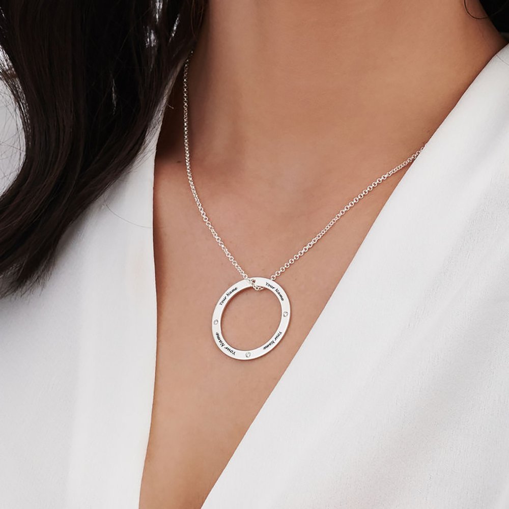 Personalized silver circle necklace with engraved names and diamonds, a custom pendant gift for women.