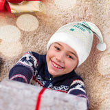 Custom Christmas Santa hat with YOUR DESIGN HERE, a happy boy holding a gift, perfect for holiday parties.