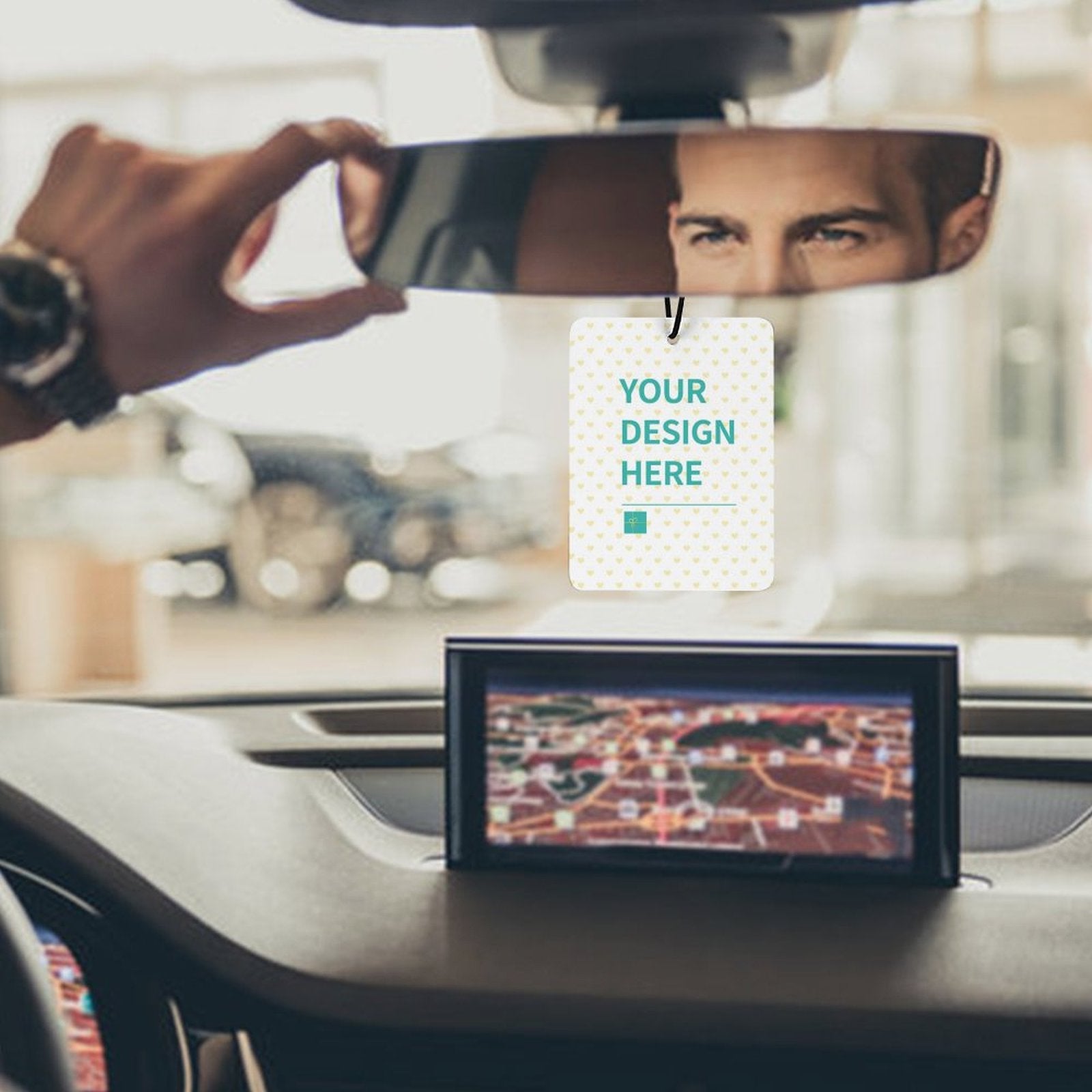 Custom air freshener with 'YOUR DESIGN HERE' text, hanging in car, personalized design for car decor.