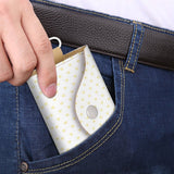 White PU leather keybag with yellow heart pattern being put in pocket, key holder for men and women.