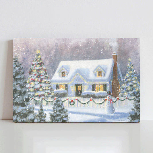 Home for Christmas canvas print. Snowy house with Christmas lights, trees, and snowman. Made in USA.