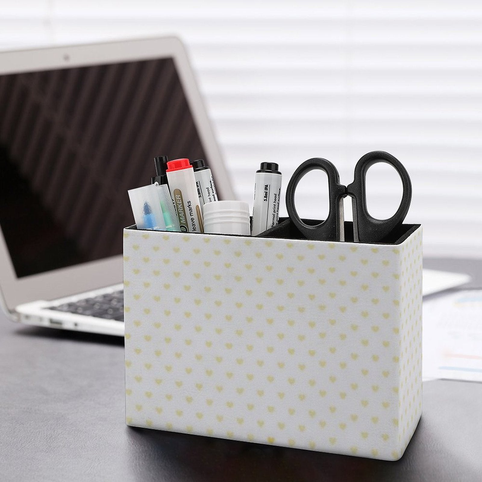 Heart-patterned pen holder on desk with office supplies. PU leather desk organizer for office and school supplies.