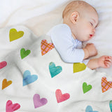 Baby sleeping under a colorful heart-patterned lamb wool fleece blanket, perfect for comfort and warmth.