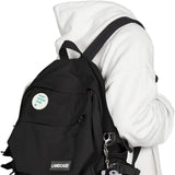 Customizable badge on black backpack, featuring 'YOUR DESIGN HERE' text, ideal for personalization and gifts, MyArtsyGift.