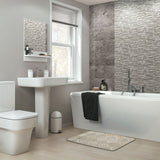 Bathroom with non-slip bath rug. Modern bathroom design, white bathtub, toilet, and bath mat.