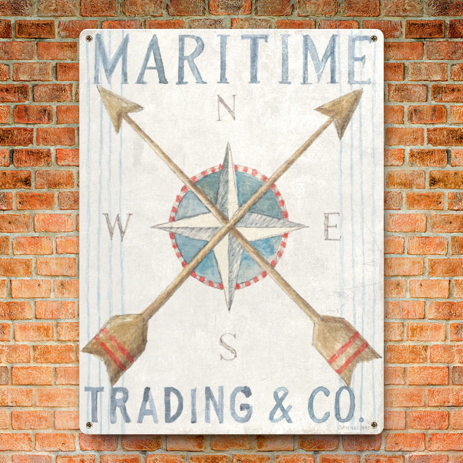 Nautical metal sign with compass design, Maritime Trading & Co text on brick wall, ideal for home decor.