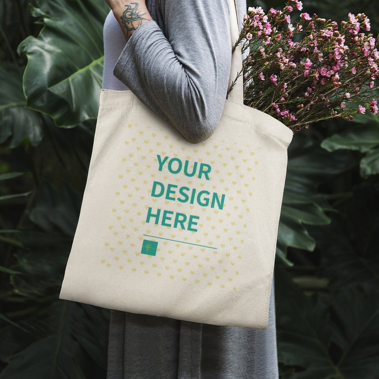 Customizable canvas tote bag with YOUR DESIGN HERE design, perfect for carrying flowers or shopping.