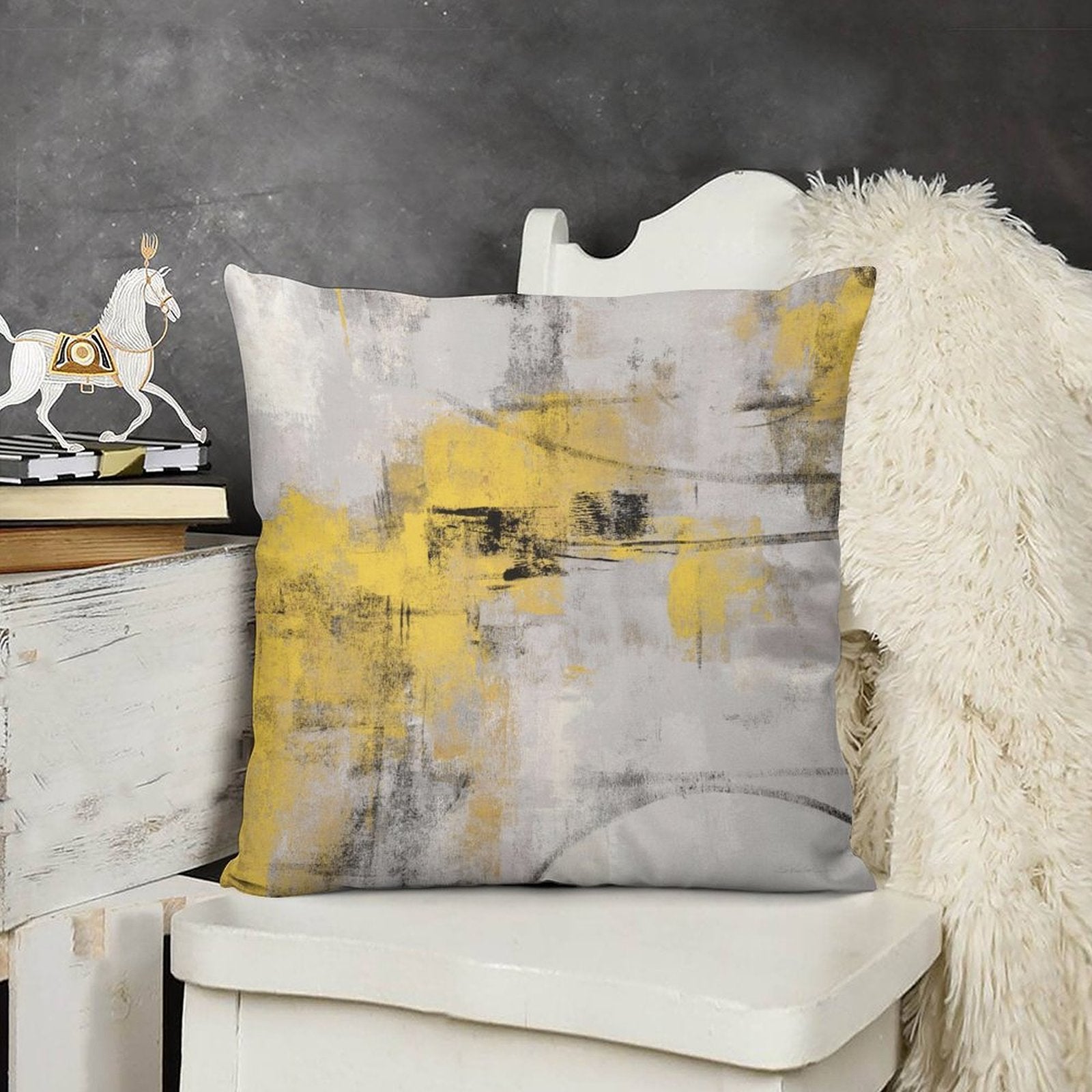 Short plush throw pillow cover with abstract art in yellow, gray, black, and displayed on white chair, home decor
