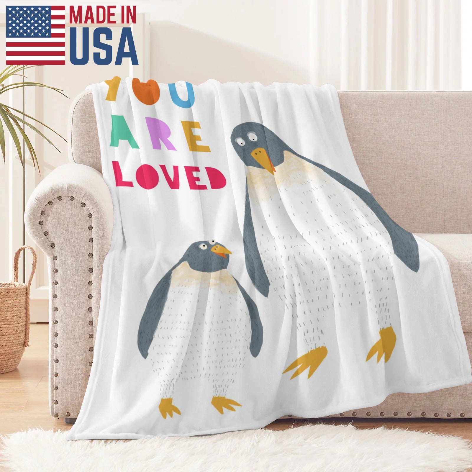 Penguin flannel blanket with "YOU ARE LOVED" text. Made in USA, super soft and cozy