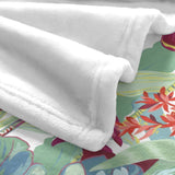 White flannel blanket with tropical plants and flower design. Soft and cozy, perfect for sofa or bed.