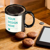 Personalized black ceramic mug with 'YOUR DESIGN HERE', coffee, and muffins, perfect for MyArtsyGift gifts.