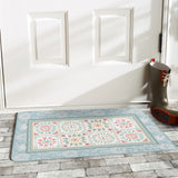 Blue floral desert door mat in front of a white door. Ideal for indoor or outdoor use.
