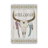 Metal tin sign, Bohemian "WELCOME" bull skull with feathers on wood background. Made in USA.