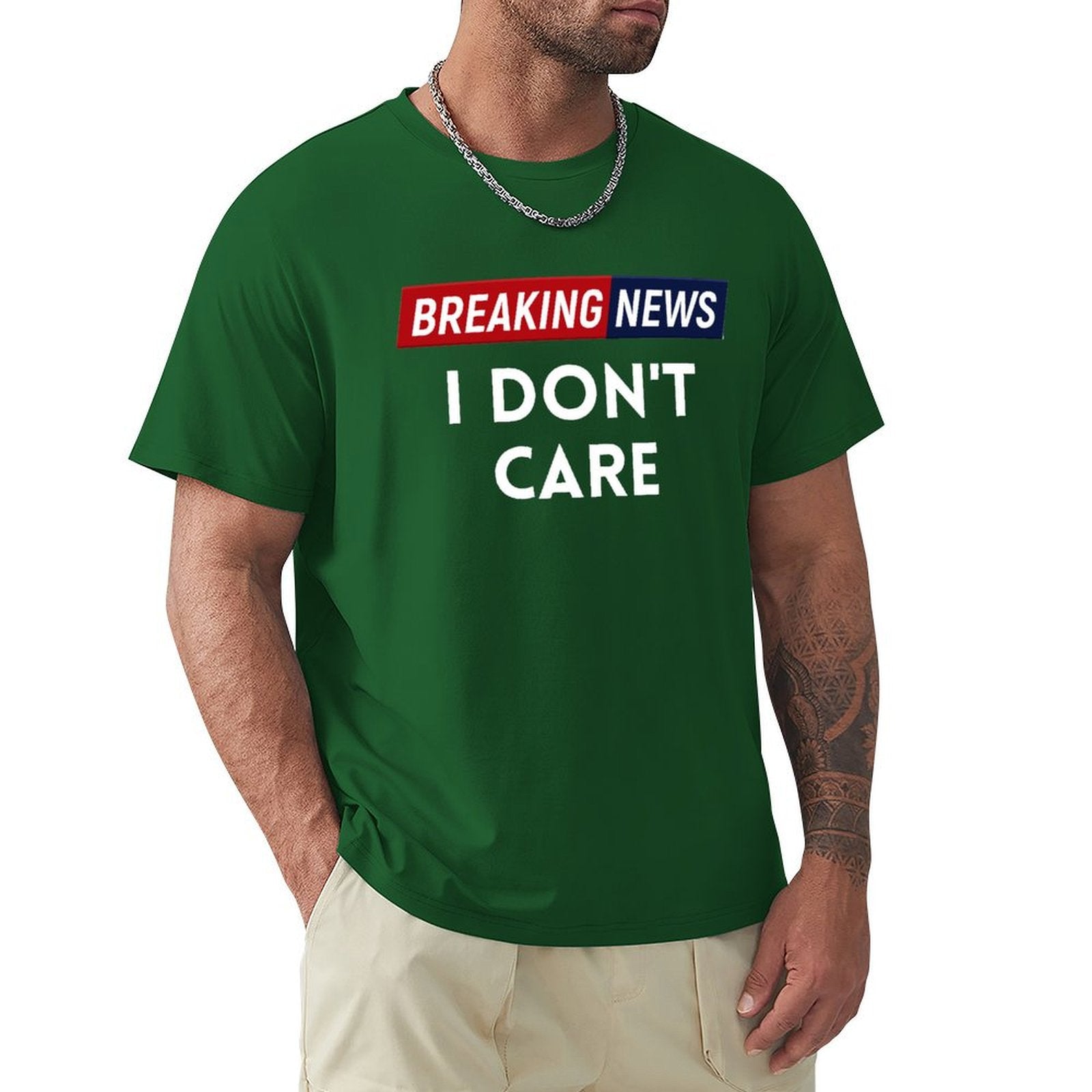 Men's green crew neck t-shirt with "Breaking News I Don't Care" graphic, cotton tee.