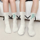 Customizable holding hands socks with 'YOUR DESIGN HERE' text, perfect gift for couples. White socks made of polyester fiber.