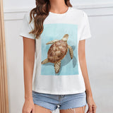 White women's t-shirt with sea turtle graphic print, summer fashion, crewneck tee.