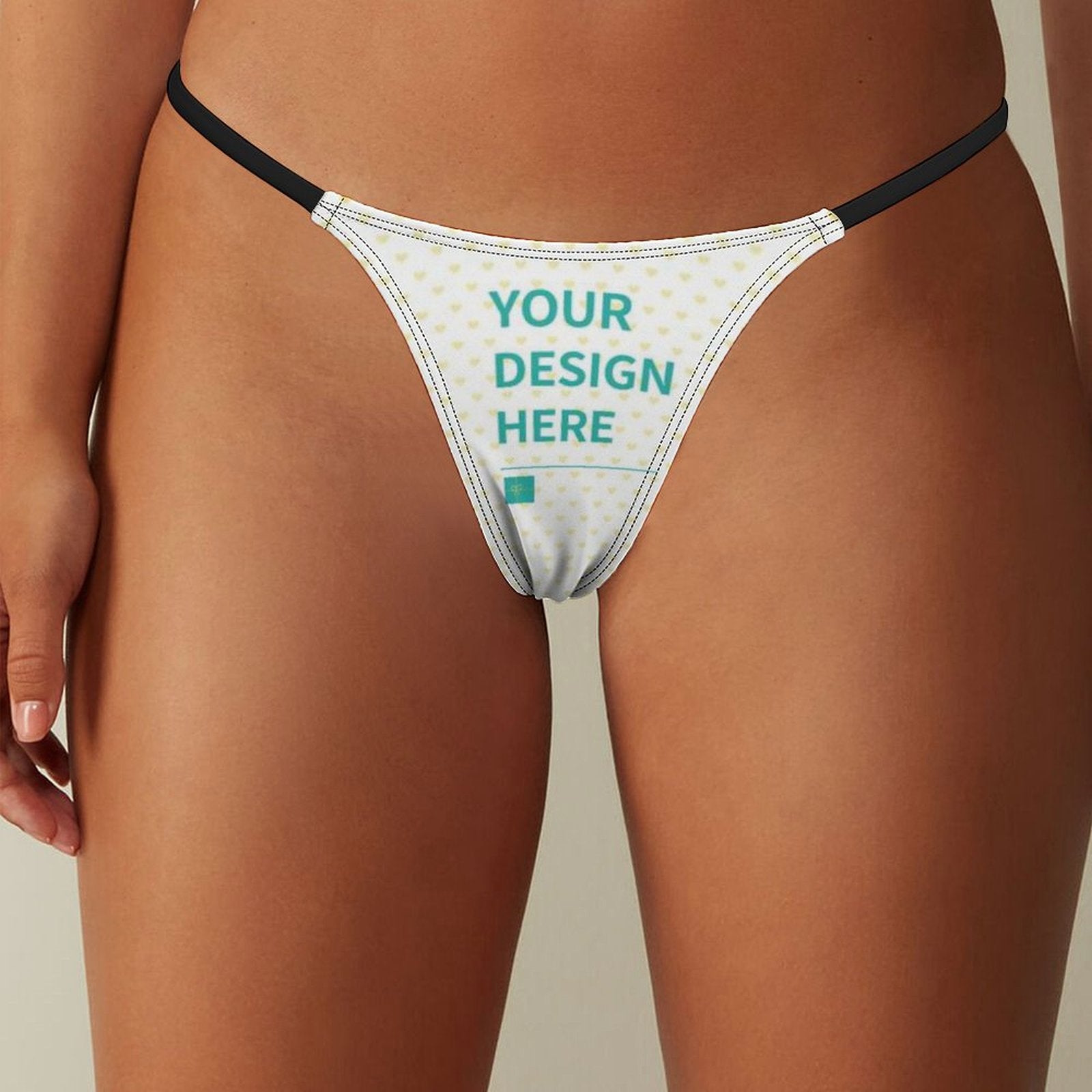 Custom thong for women with 'YOUR DESIGN HERE' text, white fabric, yellow hearts pattern, personalized panties.