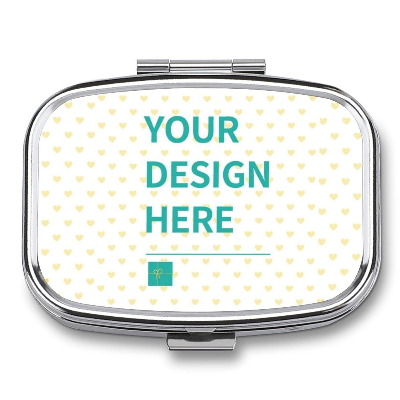 Customizable pill box featuring 'YOUR DESIGN HERE' design, perfect for personalized travel gifts. Metal with heart pattern