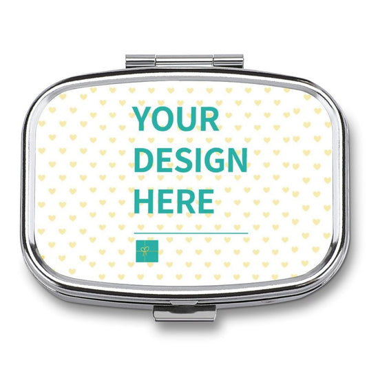Customizable pill box featuring 'YOUR DESIGN HERE' design, perfect for personalized travel gifts. Metal with heart pattern