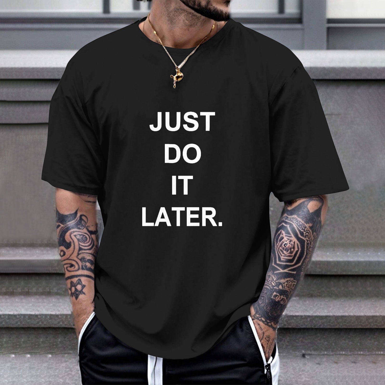 Black Gildan unisex T-shirt with "JUST DO IT LATER" print; comfortable cotton tee for casual wear.