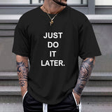 Black Gildan unisex T-shirt with "JUST DO IT LATER" print; comfortable cotton tee for casual wear.