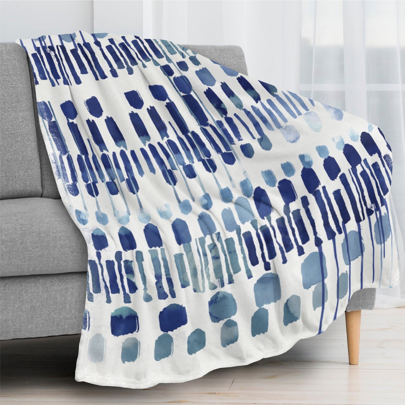 Modern blue abstract flannel blanket draped over a sofa, perfect for sofa, couch, and bed