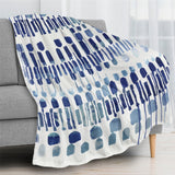 Modern blue abstract flannel blanket draped over a sofa, perfect for sofa, couch, and bed