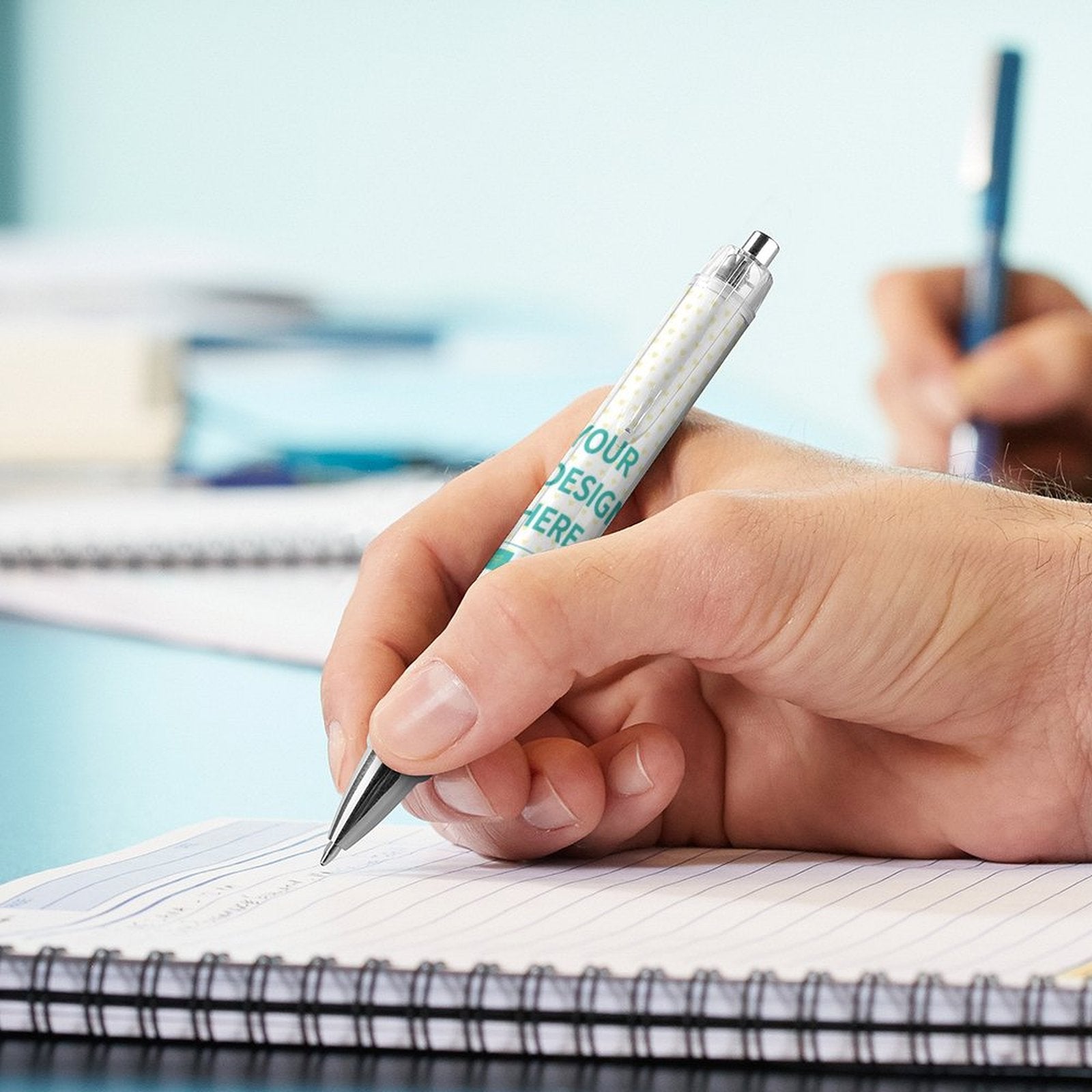 Personalized PC ballpoint pen being used to write, highlighting custom design area, perfect for student or graduation gifts.