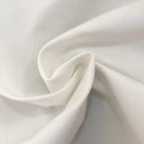 White cotton-linen fabric close-up. Durable, soft material for personalized throw pillow cases, perfect for home decor.
