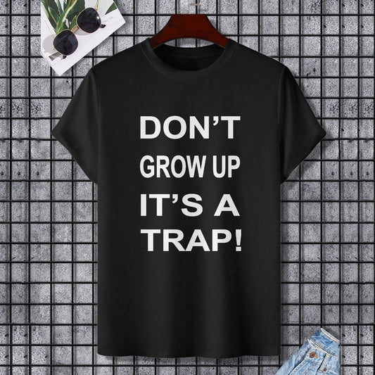 Black Gildan Unisex T-shirt with "DON'T GROW UP IT'S A TRAP!" text, comfortable cotton fabric.