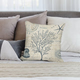 Vintage map design plush pillow cover with coral and nautical theme on sofa.