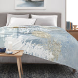 Blue winter forest flannel blanket on bed, featuring a snowy forest and deer design, for sofa and bed