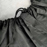 Black tire cover with drawstring closure for RV and SUV tire protection. Waterproof and durable wheel cover.