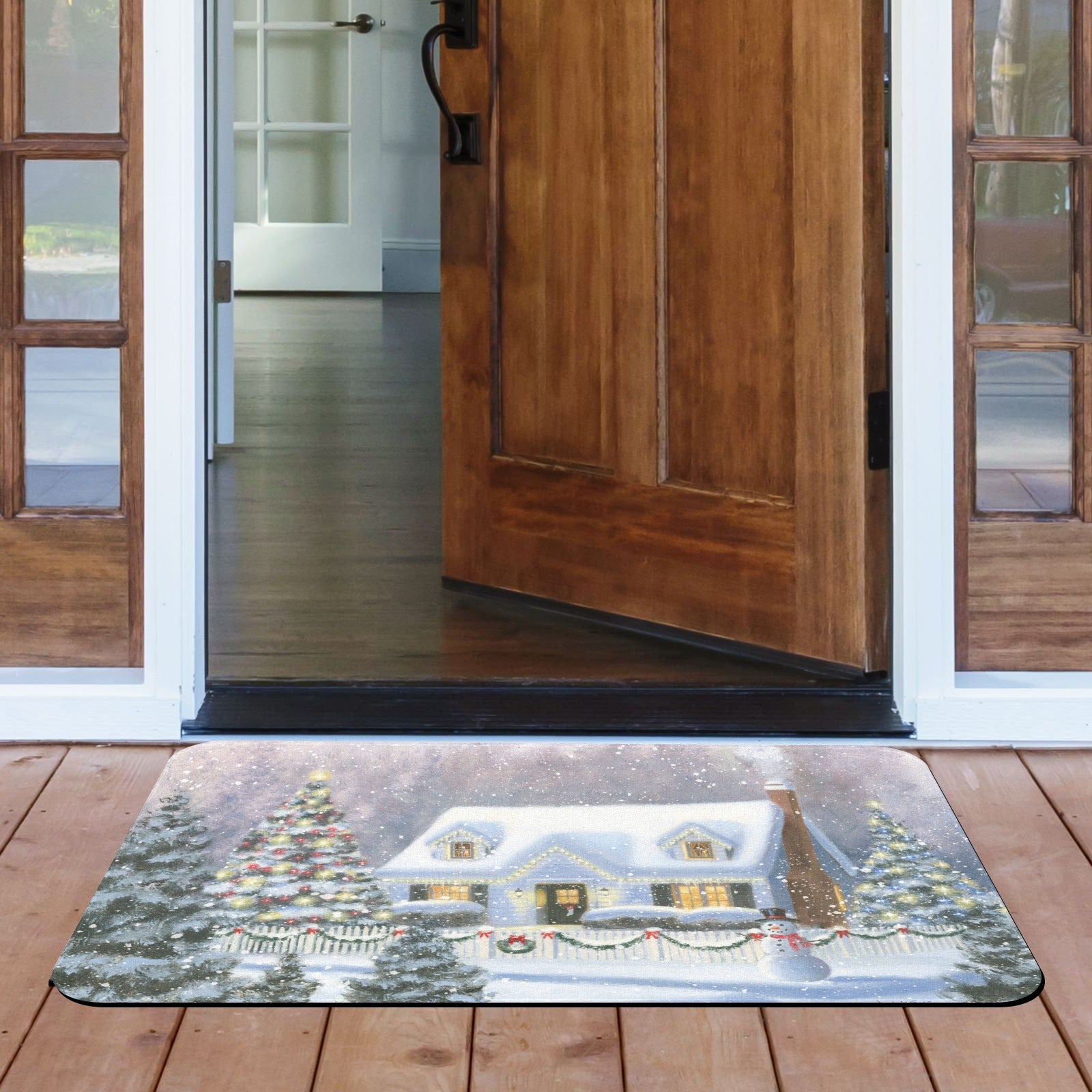 Christmas door mat with snowy house scene, suitable for indoor and outdoor use.