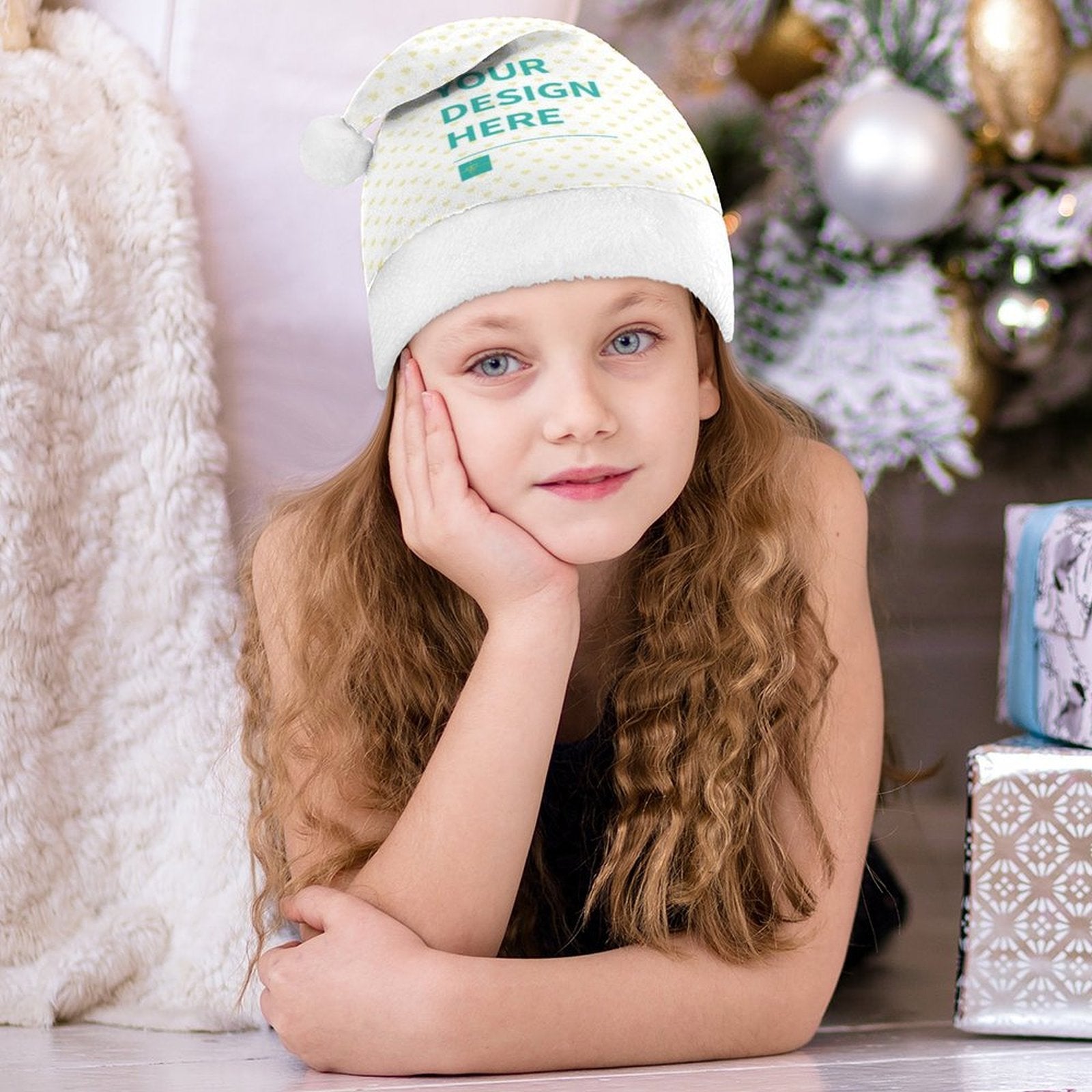 Young girl wearing a custom Christmas Santa hat with "YOUR DESIGN HERE" text; perfect for Xmas parties.