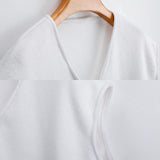 White women's V-neck sweater vest close-up, showcasing fabric texture and design details for fall outfits
