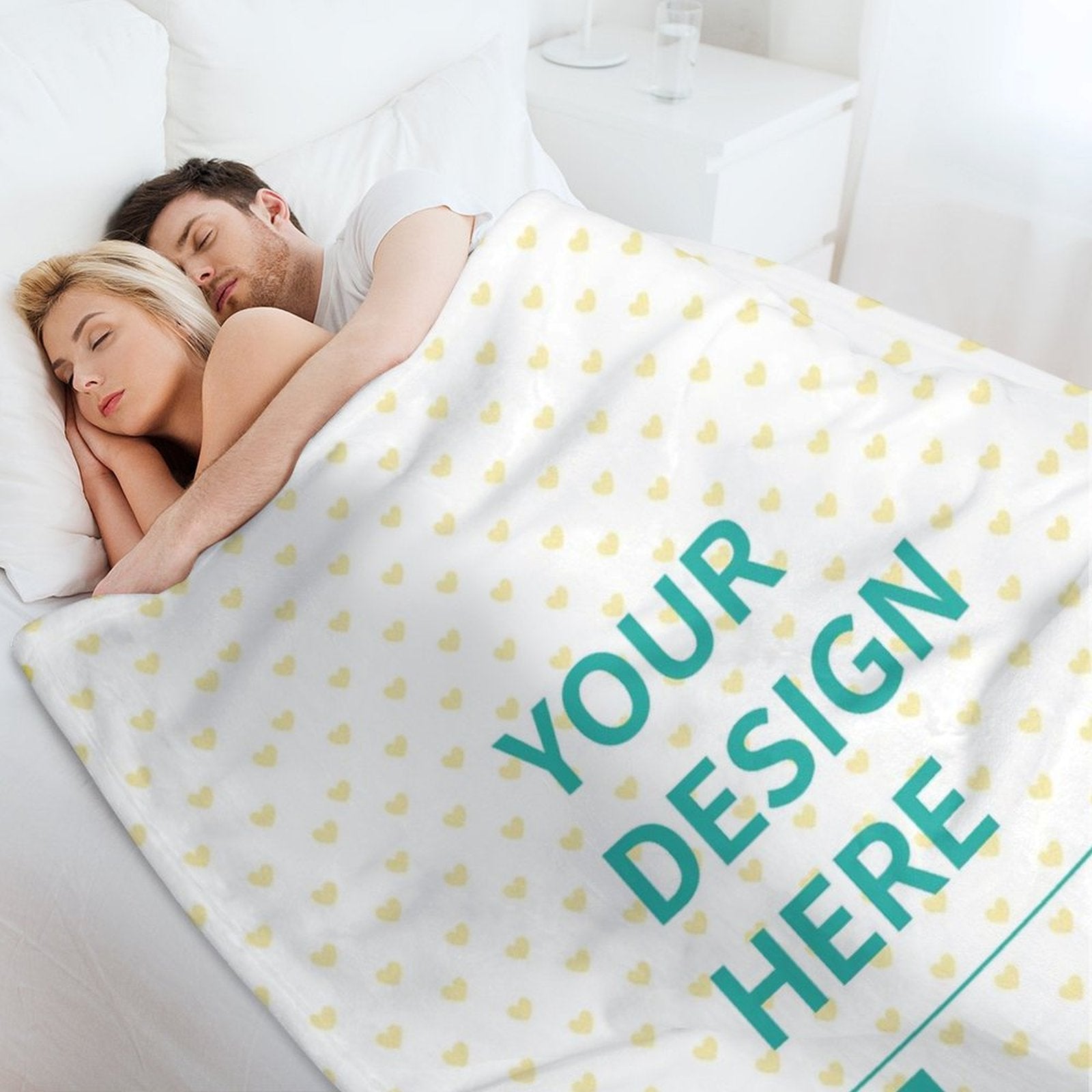 Custom fleece blanket with 'YOUR DESIGN HERE' text, heart pattern, and couple sleeping in bed.