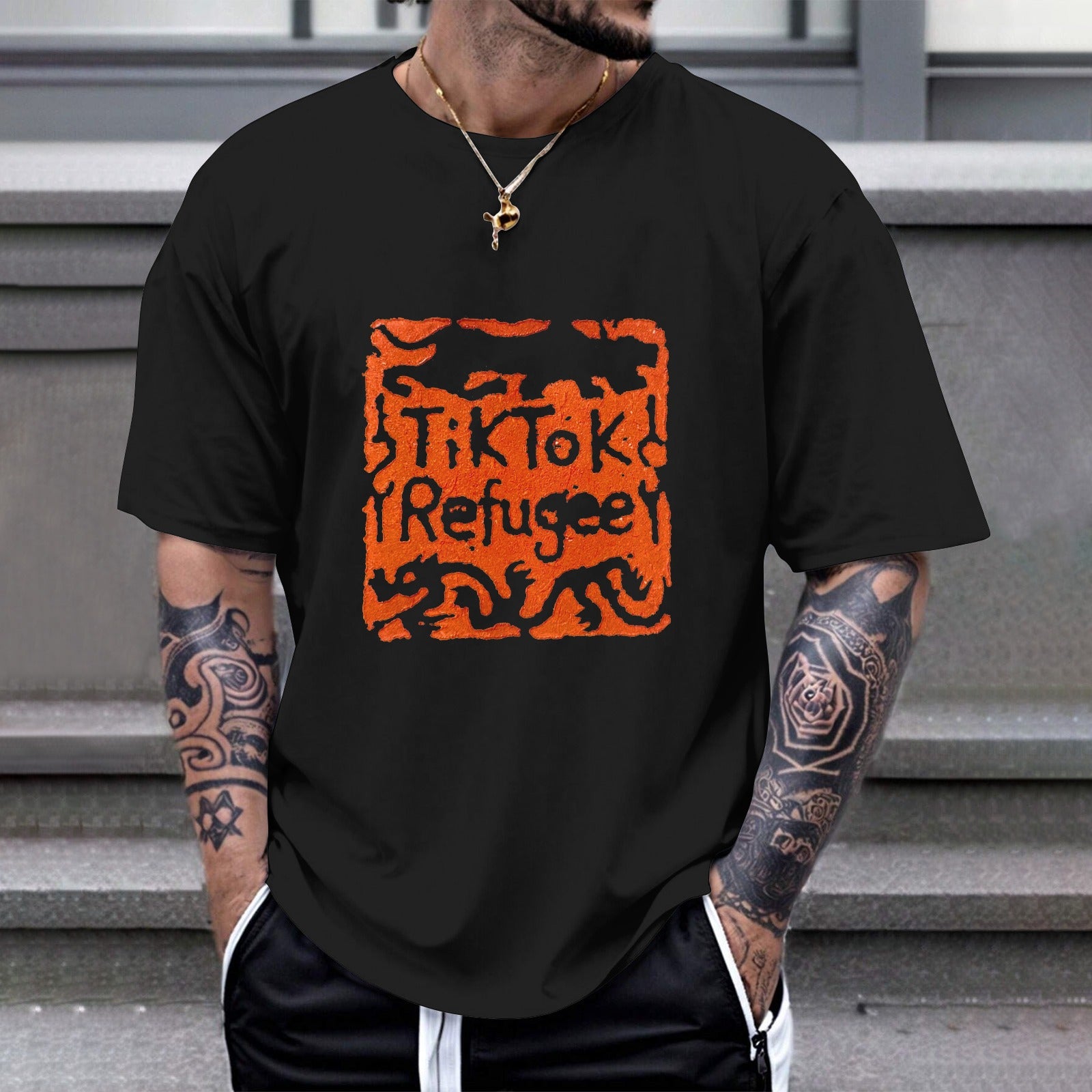 Black Gildan Unisex TikTok Refugee T-shirt with orange stamp design on chest, cotton tee