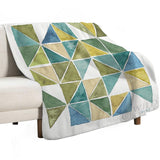 Geometric fleece blanket, green and blue triangles, for bed, couch, or travel. Made with soft, durable lamb wool.