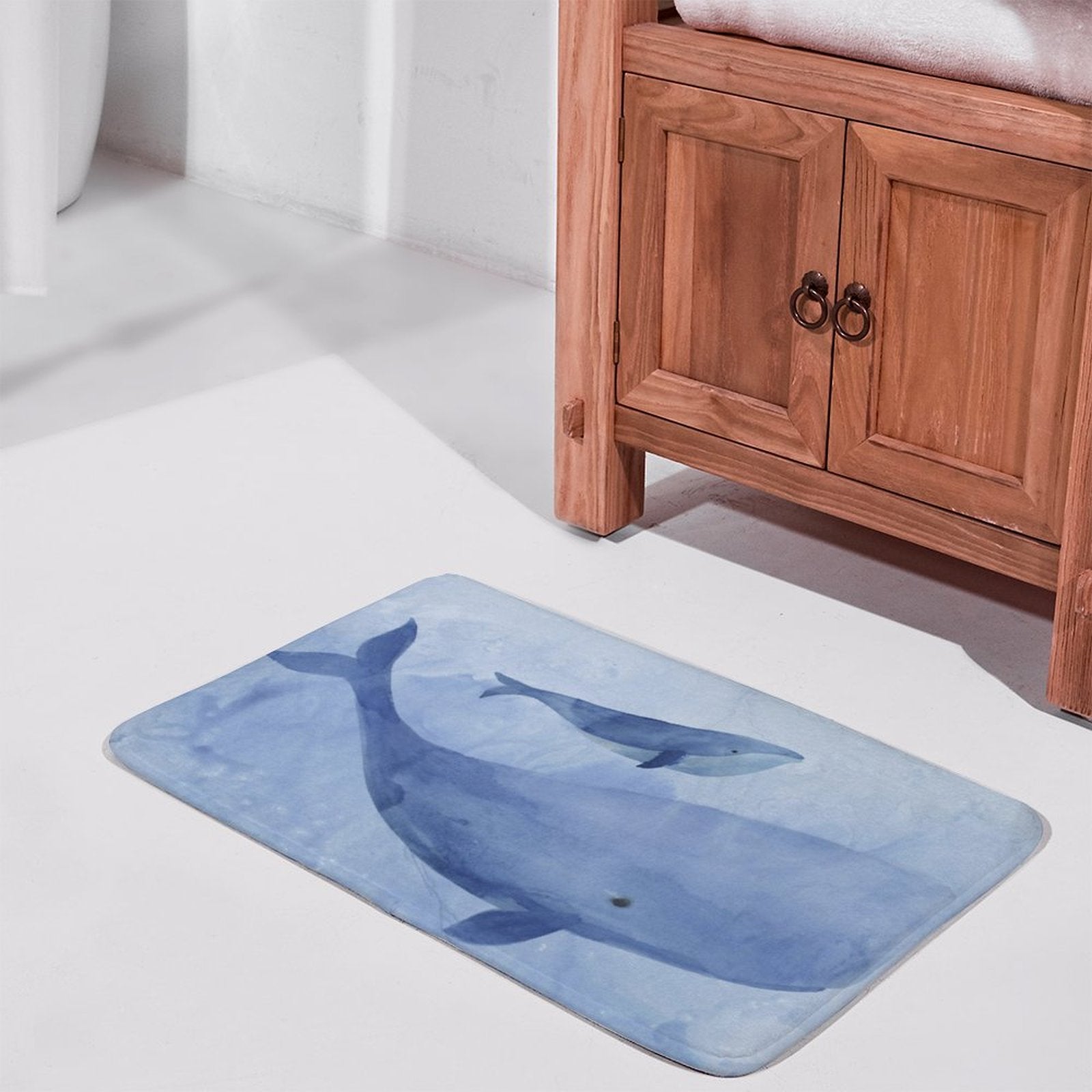 Coral velvet bath rug with whale watercolor design. Non-slip and absorbent bathroom rug.