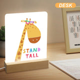 Giraffe acrylic night light with wooden base and 'STAND TALL' text. A perfect gift for kids and bedroom decor.