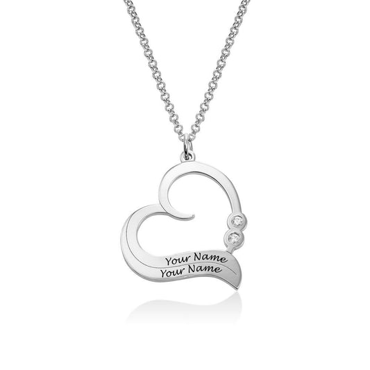 Heart-shaped personalized name necklace in silver. Custom engraved pendant jewelry for women. Includes customer's names.