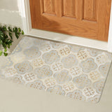 Boho doormat with quatrefoil pattern in gold and cream, ideal for indoor or outdoor use.