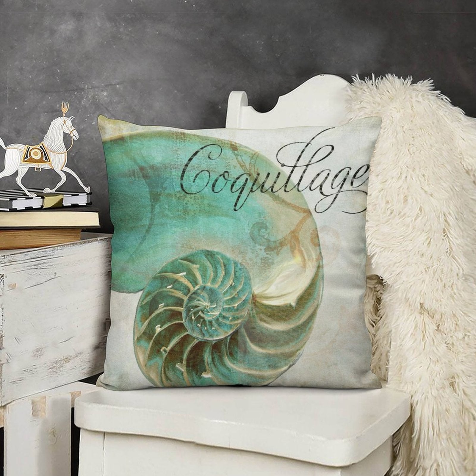 Teal nautilus shell design pillow cover with "Coquillage" script, soft short plush for sofa or couch decor.