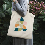 Mid Century Geo II canvas tote bag with Wild Apple logo, ideal for shopping, cotton blend, with pink flowers.