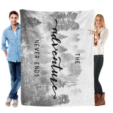 Black and white misty forest flannel blanket with "adventure never ends" text, made in USA